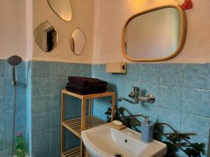 a bathroom with a sink and two mirrors on the wall at Ubytovanie na Hasičskej ulici in ľubochňa
