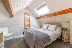 a bedroom with a bed and a skylight at The Scullery - a quirky annex with wood fire in Huddersfield