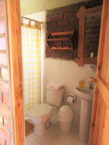 a small bathroom with a toilet and a sink at Posada Edelweiss in Oxapampa