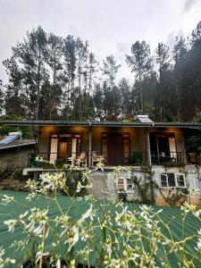 a house that is sitting in the water at Rowinrich Cottages in Ella