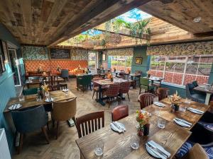 a dining room with wooden tables and chairs at Blue Ball Inn, Sandygate, Exeter in Exeter