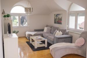 a living room with a couch and a table at Casa Bella Loznica in Loznica
