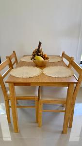 a wooden table with a bowl of fruit on it at White Pearl 2BR Beachfront House Malibu Seaview in Mae Haad +17 photos