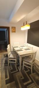 une salle à manger avec une table et deux chaises dans l'établissement Escapadă urbană, confort, curte privată și parcare, à Piatra Neamţ