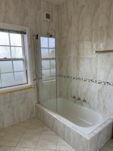a bathroom with a tub and a window at Echo point Cottage in Katoomba