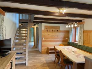 a kitchen and dining room with a staircase and a table at Moarhof in Aich