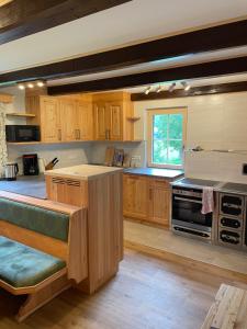 a large kitchen with wooden cabinets and a stove at Moarhof in Aich