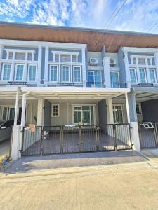 a blue house with a fence in front of it at The Golden Town CNX private house in Chiang Mai