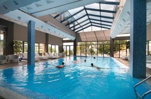 a group of people swimming in a swimming pool at Apartment - Studio Cucetno in Sandanski