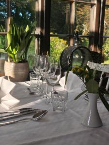 a table with wine glasses on a white table cloth at Baldersnäs Herrgård in Dals Långed