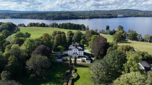 an aerial view of a house on the shore of a lake at Baldersnäs Herrgård in Dals Långed
