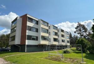 Un edificio de apartamentos con un campo de fútbol enfrente. en Studio with glazed balcony, en Kotka