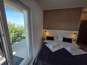 a bedroom with a bed and a large window at Bed & Breakfast Dora in Rovanjska
