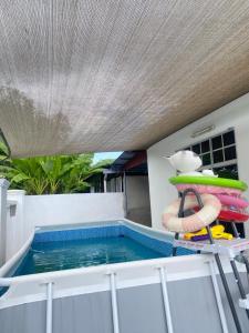 a small swimming pool with a pool noodle and a life preserver at Villa Amani Homestay in Sungai Petani