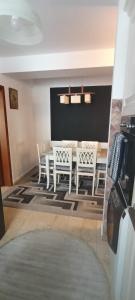 a dining room with a table and chairs at Escapadă urbană, confort, curte privată și parcare in Piatra Neamţ