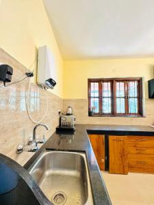 a kitchen with a sink and a counter top at 2 bedroom perfect stay villas in Anjuna