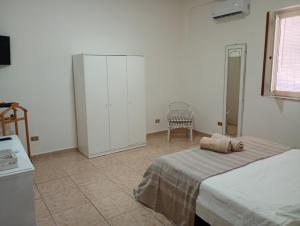 a bedroom with a bed and a chair in it at Mini appartamento a Marcianise in Marcianise