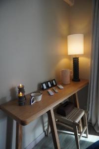 a wooden table with a lamp and a lamp at Casa Mare - Sea View, Home Cinema, Parking in Menton +17 photos