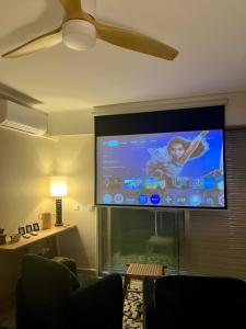 a large flat screen tv on a wall in a living room at Casa Mare - Sea View, Home Cinema, Parking in Menton