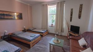 a living room with two beds and a couch at Ubytovaní U Dvora in Bohumín
