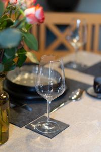 a wine glass sitting on top of a table at Ferienwohnung Bergliebe in Weißbach