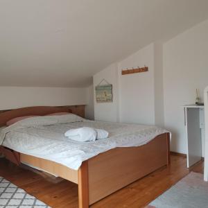 a bedroom with a bed with a white mattress at Zenith Center Apartment in Ohrid