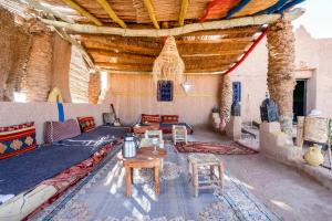a living room with a couch and a table at Camp Ayour Mhamid in Mhamid