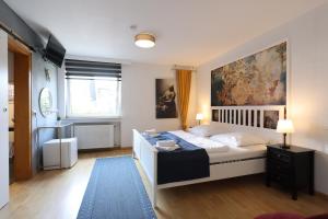 a bedroom with a bed and a painting on the wall at Hotel Seeblick Obermaubach in Obermaubach +57 photos