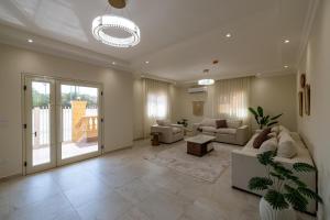 a large living room with a couch and a table at Welhome Stays Aparthotel in Cairo