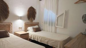 カラン・ポルテルにあるEl Escape - confort y calmaのベッドが2つと窓があるホテルの部屋