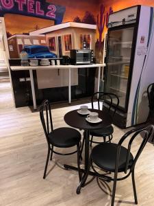 a table and chairs in front of a kitchen at Hotel Santiago Yungay in Santiago