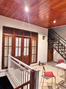 a living room with a wooden ceiling and a staircase at Misty Hills Lakeview Lounge in Kandy