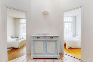 a room with a blue cabinet and two mirrors at St Agne - Maison 3 ch patio Toulouse in Toulouse