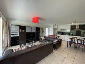 a living room with two couches and a kitchen at Villa 3 chambres proche océan, Wi-Fi, Animaux OK - FR-1-379-114 in Messanges