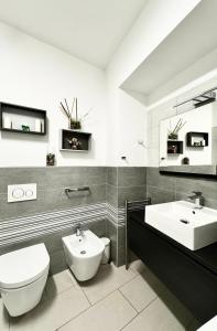 a bathroom with a toilet and a bidet and a sink at Life Studio & City Bike in Bolzano +79 photos