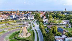 an aerial view of a small town with a clock tower at Moderne vakantie woning in Domburg
