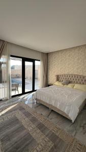 Postel nebo postele na pokoji v ubytování Dream Villa Chalet استراحة دريم فيلا