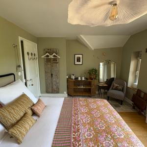 a bedroom with a large bed with a rug on it at La Grenouillère - Chambre d'hôtes de charme in Ballan-Miré