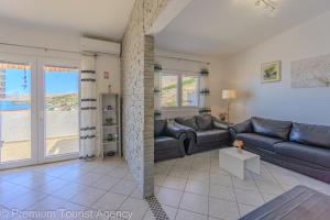 a living room with a couch and a table at Lara & Vito in Metajna