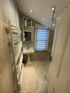 a bathroom with a sink and a toilet and a window at Townhouse 30 mins from central London in Sevenoaks in Sevenoaks +23 photos