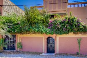a house with flowers on the side of it at peaceful apartment in Taroudant