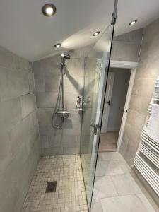 a bathroom with a shower with a glass door at Townhouse 30 mins from central London in Sevenoaks in Sevenoaks