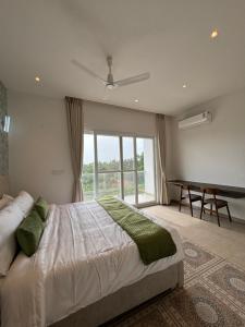 a bedroom with a bed and a pool table in it at Red Apple Farm Villa by Mystic Hotels 