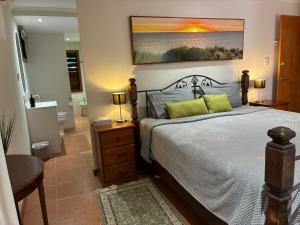 a bedroom with a large bed and a bathroom at Oasis, in leafy Whitfield. in Edge Hill