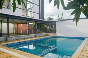 an external view of a house with a swimming pool at Red Apple Farm Villa by Mystic Hotels 