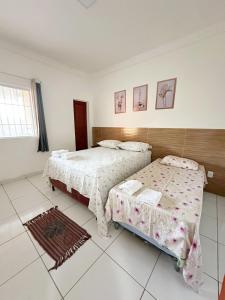 a bedroom with two beds in a room at Lar de Maria Aguiar in Barreirinhas