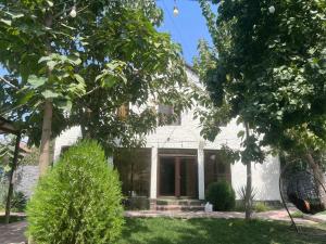 a white house with trees in front of it at Գոլդ հաուս in Garni