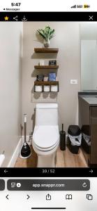 a bathroom with a white toilet in a room at Janna hospitality in San Diego