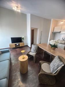 a living room with a couch and a table and chairs at Maja Apartment 3 in Funtana