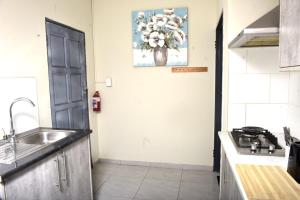 a kitchen with a sink and a counter top at Private Guest suite in Ferndale in Johannesburg +10 photos
